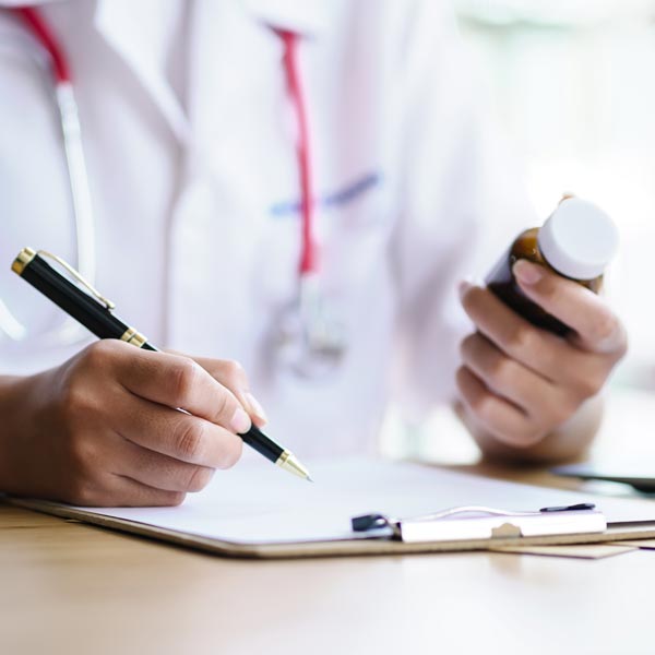 doctor holding medicine bottle