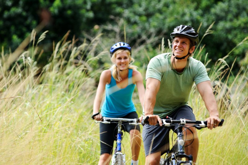 The couple bicycling in the forest area at Los Altos, CA 