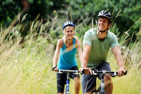 couple bicycling with all gears